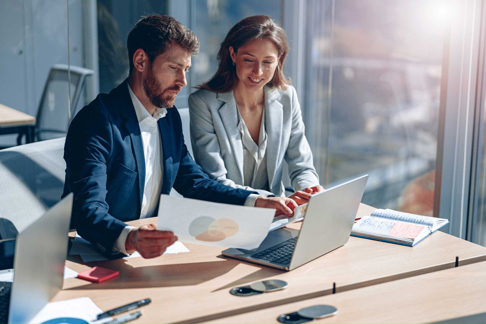 Financial professionals looking at computer