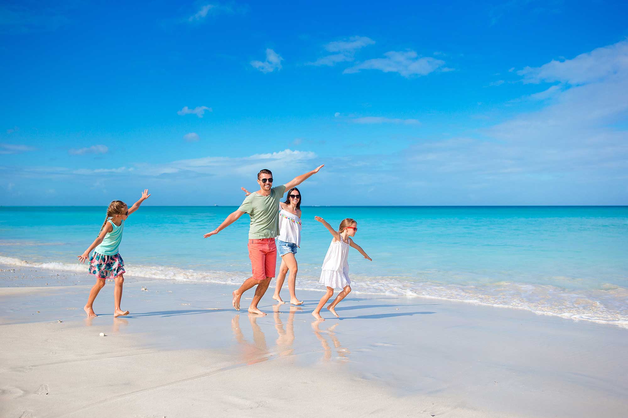 Happy family on the beach during summer vacation