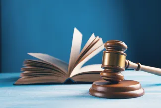 judges gavel and open book on table by Sasun Bughdaryan courtesy of Unsplash.