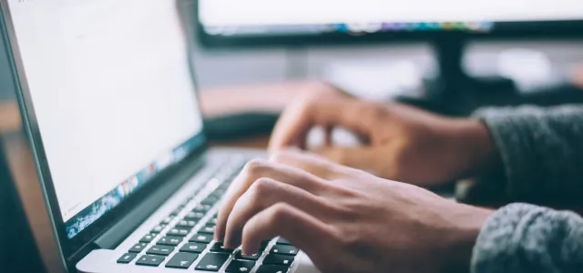 person using MacBook Pro by Glenn Carstens-Peters courtesy of Unsplash.