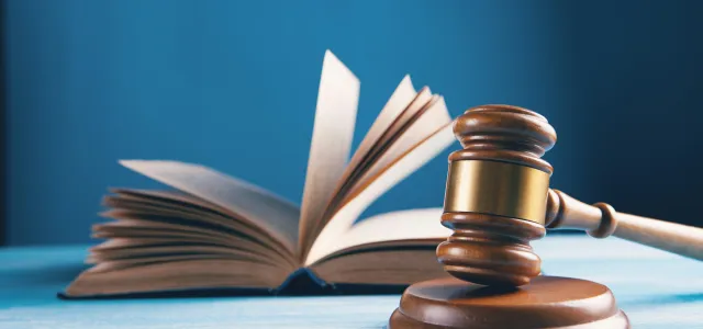 judges gavel and open book on table by Sasun Bughdaryan courtesy of Unsplash.